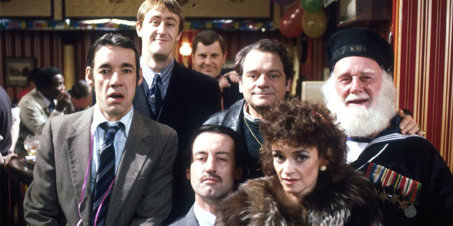 Only Fools And Horses. Image shows from L to R: Trigger (Roger Lloyd-Pack), Rodney (Nicholas Lyndhurst), Mike (Kenneth MacDonald), Boycie (John Challis), Del (David Jason), Marlene (Sue Holderness), Uncle Albert (Buster Merryfield). Copyright: BBC. Only Fools And Horses. Image shows from L to R: Trigger (Roger Lloyd-Pack), Rodney (Nicholas Lyndhurst), Mike (Kenneth MacDonald), Boycie (John Challis), Del (David Jason), Marlene (Sue Holderness), Uncle Albert (Buster Merryfield). Copyright: BBC.