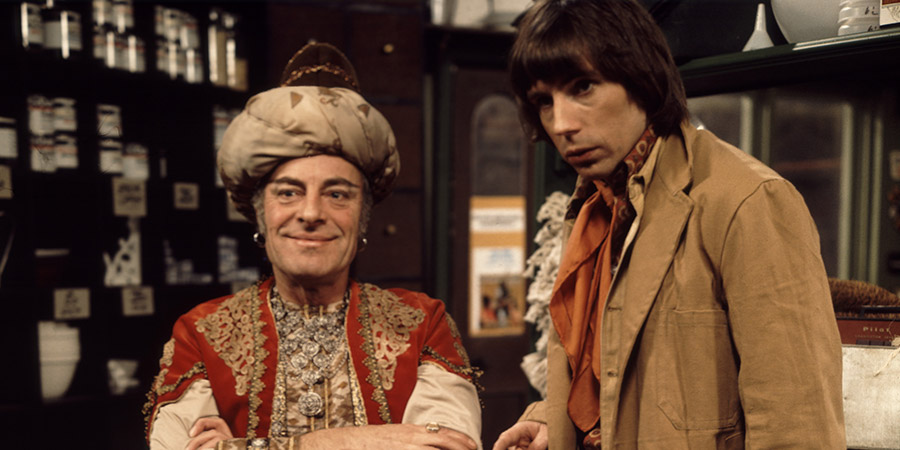 Pardon My Genie. Image shows from L to R: The Genie (Hugh Paddick), Hal (Ellis Jones). Copyright: Thames Television. Pardon My Genie. Image shows from L to R: The Genie (Hugh Paddick), Hal (Ellis Jones). Copyright: Thames Television.
