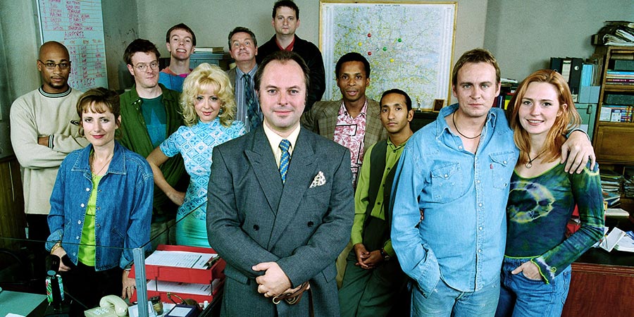 Roger Roger. Image shows from L to R: Andre (Terence Maynard), Reen (Pippa Guard), Cambridge (Chris Larkin), Marlon (Ricci Harnett), Tina (Barbara Durkin), Baz (David Ross), Sam (Robert Daws), Barry (Jonathan Moore), Henry (Jude Akuwudike), Rajiv (Paul Sharma), Phil (Philip Glenister), Chrissie (Helen Grace). Copyright: BBC. Roger Roger. Image shows from L to R: Andre (Terence Maynard), Reen (Pippa Guard), Cambridge (Chris Larkin), Marlon (Ricci Harnett), Tina (Barbara Durkin), Baz (David Ross), Sam (Robert Daws), Barry (Jonathan Moore), Henry (Jude Akuwudike), Rajiv (Paul Sharma), Phil (Philip Glenister), Chrissie (Helen Grace). Copyright: BBC.