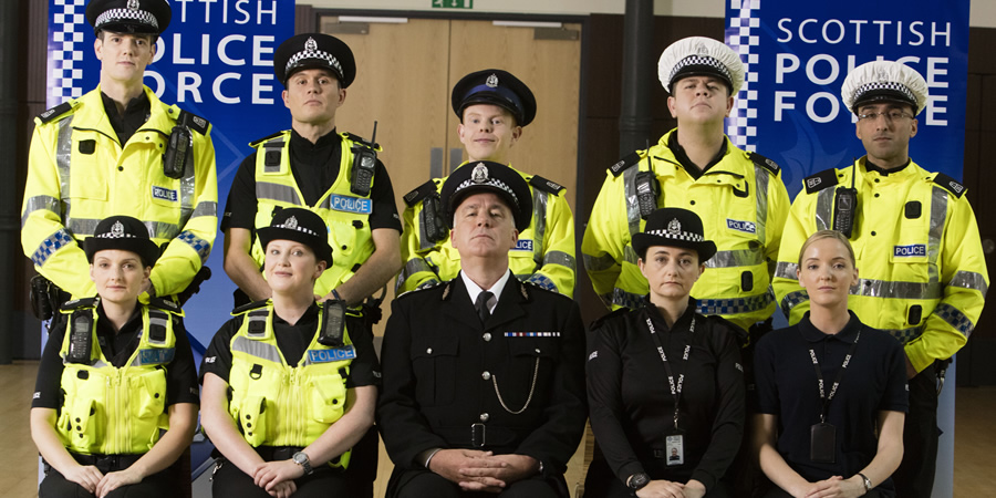 Scot Squad. Image shows from L to R: PC Jack McLaren (Jordan Young), PC Charlie McIntosh (Chris Forbes), Officer/Acting Sgt. Ken Beattie (James Allenby-Kirk), PC Hugh McKirdy (Graeme Stevely), PC Surjit Singh (Manjot Sumal), PC Jane Mackay (Ashley Smith), PC Sarah Fletcher (Sally Reid), Chief Commissioner Cameron Miekelson (Jack Docherty), Sergeant Karen Ann Millar (Karen Bartke), Maggie LeBeau (ML Stone). Copyright: The Comedy Unit. Scot Squad. Image shows from L to R: PC Jack McLaren (Jordan Young), PC Charlie McIntosh (Chris Forbes), Officer/Acting Sgt. Ken Beattie (James Allenby-Kirk), PC Hugh McKirdy (Graeme Stevely), PC Surjit Singh (Manjot Sumal), PC Jane Mackay (Ashley Smith), PC Sarah Fletcher (Sally Reid), Chief Commissioner Cameron Miekelson (Jack Docherty), Sergeant Karen Ann Millar (Karen Bartke), Maggie LeBeau (ML Stone). Copyright: The Comedy Unit.