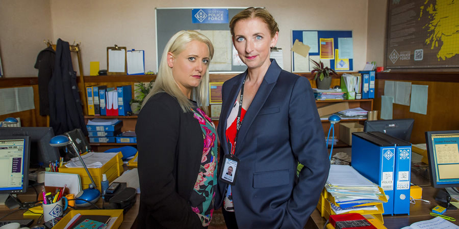 Scot Squad. Image shows from L to R: DC Andrea McGill (Louise McCarthy), DC Megan Squire (Julie Wilson Nimmo). Copyright: The Comedy Unit. Scot Squad. Image shows from L to R: DC Andrea McGill (Louise McCarthy), DC Megan Squire (Julie Wilson Nimmo). Copyright: The Comedy Unit.