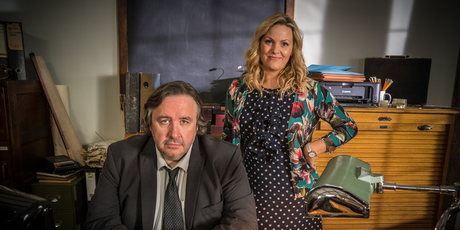 Shakespeare & Hathaway - Private Investigators. Image shows from L to R: Frank Hathaway (Mark Benton), Luella Shakespeare (Jo Joyner). Copyright: BBC. Shakespeare & Hathaway - Private Investigators. Image shows from L to R: Frank Hathaway (Mark Benton), Luella Shakespeare (Jo Joyner). Copyright: BBC.