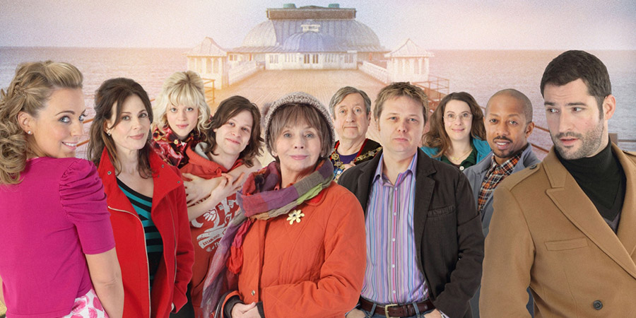 Sugartown. Image shows from L to R: Emily Shirley (Miranda Raison), Sam (Sally Dexter), Carmen (Georgia King), Travis (Rob Kendrick), Margery (Sue Johnston), Ron (Philip Jackson), Jason Burr (Shaun Dooley), Anne (Juliet Cowan), Michael (Paul J Medford), Max Burr (Tom Ellis). Copyright: Shed Productions. Sugartown. Image shows from L to R: Emily Shirley (Miranda Raison), Sam (Sally Dexter), Carmen (Georgia King), Travis (Rob Kendrick), Margery (Sue Johnston), Ron (Philip Jackson), Jason Burr (Shaun Dooley), Anne (Juliet Cowan), Michael (Paul J Medford), Max Burr (Tom Ellis). Copyright: Shed Productions.