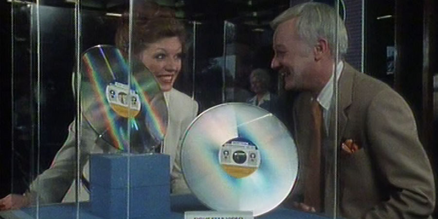 Take A Letter Mr. Jones.... Image shows from L to R: Ms. Joan Warner (Rula Lenska), Mr. Graham Jones (John Inman). Copyright: Southern Television. Take A Letter Mr. Jones.... Image shows from L to R: Ms. Joan Warner (Rula Lenska), Mr. Graham Jones (John Inman). Copyright: Southern Television.