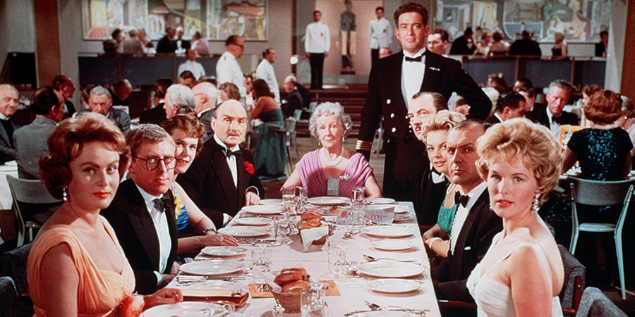 The Captain's Table. Image shows from L to R: Mrs. Daphne Porteous (Nadia Gray), Henry Lomax (John Warner), Gwenny Coke (June Jago), Major Broster (Maurice Denham), Mrs. Lomax (Nora Nicholson), Captain Albert Ebbs (John Gregson), Bernie Floate (Lionel Murton), Rosemary (Beth Rogan), Bill Coke (Bill Kerr), Mrs. Judd (Peggy Cummins). Copyright: Rank Organisation / ITV Studios. The Captain's Table. Image shows from L to R: Mrs. Daphne Porteous (Nadia Gray), Henry Lomax (John Warner), Gwenny Coke (June Jago), Major Broster (Maurice Denham), Mrs. Lomax (Nora Nicholson), Captain Albert Ebbs (John Gregson), Bernie Floate (Lionel Murton), Rosemary (Beth Rogan), Bill Coke (Bill Kerr), Mrs. Judd (Peggy Cummins). Copyright: Rank Organisation / ITV Studios.