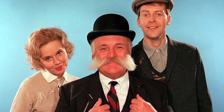 The Glums. Image shows from L to R: Eth (Patricia Brake), Pa Glum (Jimmy Edwards), Ron Glum (Ian Lavender). Copyright: London Weekend Television. The Glums. Image shows from L to R: Eth (Patricia Brake), Pa Glum (Jimmy Edwards), Ron Glum (Ian Lavender). Copyright: London Weekend Television.