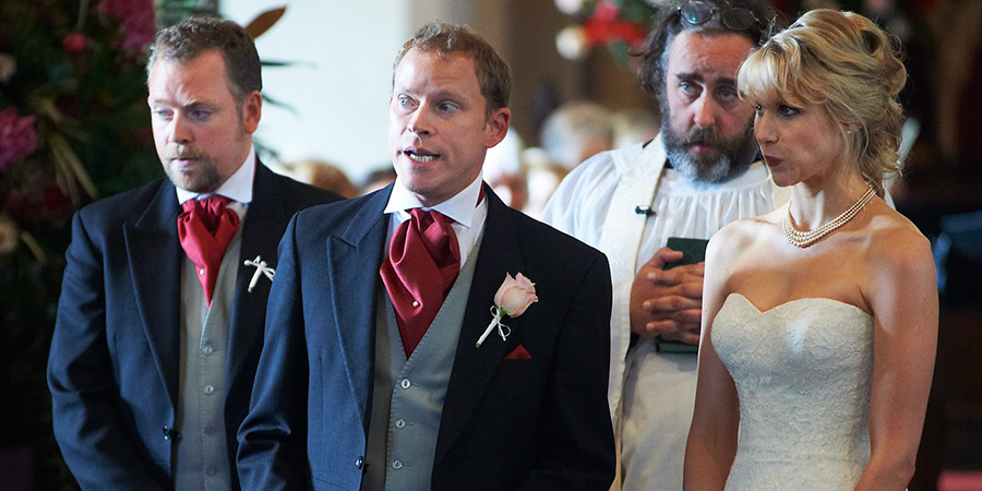 The Wedding Video. Image shows from L to R: Raif (Rufus Hound), Tim (Robert Webb), Reverend Dobbs (Angus Barnett), Saskia (Lucy Punch). Copyright: Timeless Films. The Wedding Video. Image shows from L to R: Raif (Rufus Hound), Tim (Robert Webb), Reverend Dobbs (Angus Barnett), Saskia (Lucy Punch). Copyright: Timeless Films.
