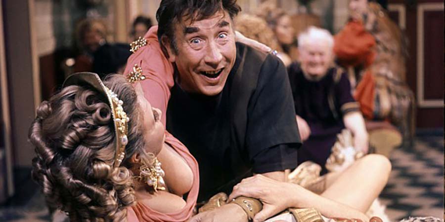 Up Pompeii. Image shows from L to R: Ammonia (Barbara Murray), Lurcio (Frankie Howerd), Ludicrus Sextus (Michael Hordern). Copyright: Associated London Films Limited. Up Pompeii. Image shows from L to R: Ammonia (Barbara Murray), Lurcio (Frankie Howerd), Ludicrus Sextus (Michael Hordern). Copyright: Associated London Films Limited.