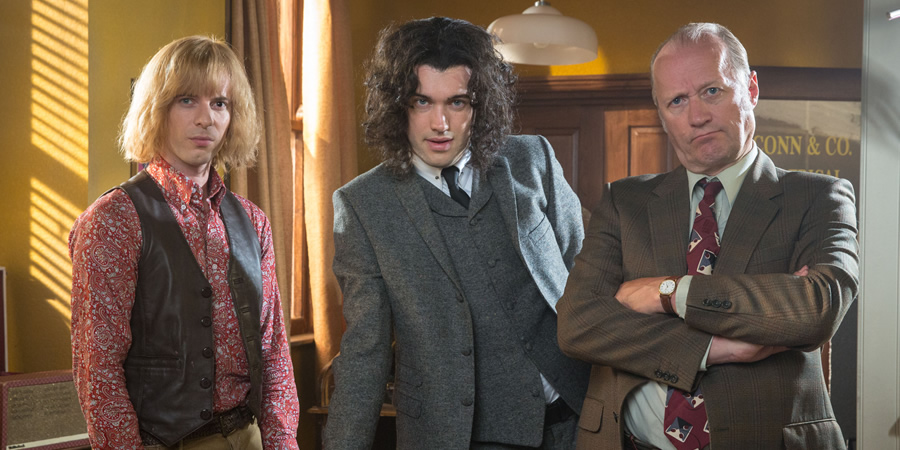 Urban Myths: When Bowie Met Bolan. Image shows from L to R: David Jones (Luke Treadaway), Mark Feld (Jack Whitehall), Leslie Conn (Adrian Edmondson). Copyright: Lion Television. Urban Myths: When Bowie Met Bolan. Image shows from L to R: David Jones (Luke Treadaway), Mark Feld (Jack Whitehall), Leslie Conn (Adrian Edmondson). Copyright: Lion Television.