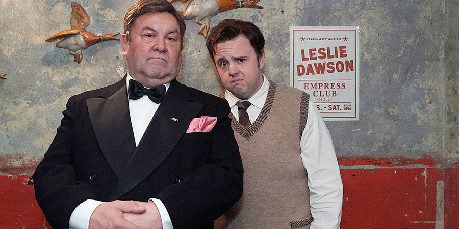 Urban Myths: Les Dawson's Parisienne Adventure. Image shows from L to R: Older Les (Mark Addy), Young Les (John Bradley). Copyright: Red Production Company. Urban Myths: Les Dawson's Parisienne Adventure. Image shows from L to R: Older Les (Mark Addy), Young Les (John Bradley). Copyright: Red Production Company.