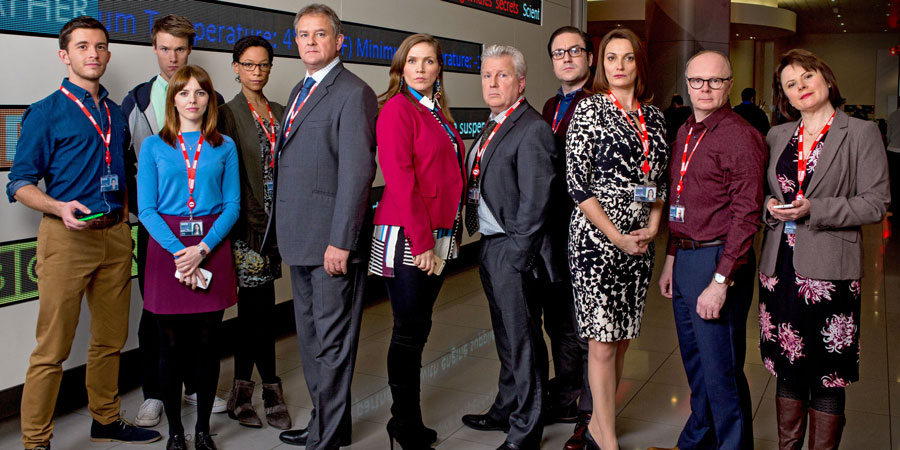 W1A. Image shows from L to R: Jack Patterson (Jonathan Bailey), Will Humphries (Hugh Skinner), Izzy Gould (Ophelia Lovibond), Lucy Freeman (Nina Sosanya), Ian Fletcher (Hugh Bonneville), Siobhan Sharpe (Jessica Hynes), Neil Reid (David Westhead), David Wilkes (Rufus Jones), Anna Rampton (Sarah Parish), Simon Harwood (Jason Watkins), Tracey Pritchard (Monica Dolan). Copyright: BBC. W1A. Image shows from L to R: Jack Patterson (Jonathan Bailey), Will Humphries (Hugh Skinner), Izzy Gould (Ophelia Lovibond), Lucy Freeman (Nina Sosanya), Ian Fletcher (Hugh Bonneville), Siobhan Sharpe (Jessica Hynes), Neil Reid (David Westhead), David Wilkes (Rufus Jones), Anna Rampton (Sarah Parish), Simon Harwood (Jason Watkins), Tracey Pritchard (Monica Dolan). Copyright: BBC.