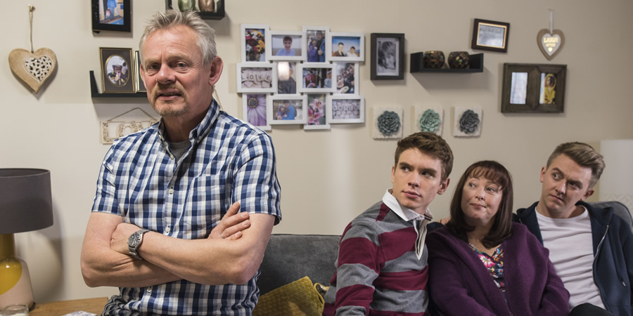 Warren. Image shows from L to R: Warren Thompson (Martin Clunes), Danny (Oscar Morgan), Anne (Lisa Millett), Charlie (Tim Preston). Copyright: Hat Trick Productions. Warren. Image shows from L to R: Warren Thompson (Martin Clunes), Danny (Oscar Morgan), Anne (Lisa Millett), Charlie (Tim Preston). Copyright: Hat Trick Productions.