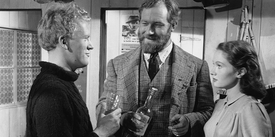 Whisky Galore!. Image shows from L to R: George Campbell (Gordon Jackson), Dr. Maclaren (James Robertson Justice), Peggy Macroon (Joan Greenwood). Copyright: Ealing Studios. Whisky Galore!. Image shows from L to R: George Campbell (Gordon Jackson), Dr. Maclaren (James Robertson Justice), Peggy Macroon (Joan Greenwood). Copyright: Ealing Studios.