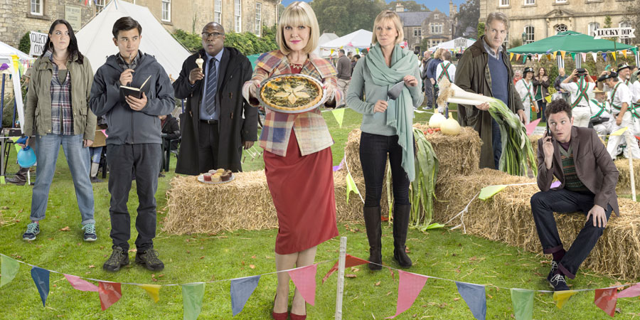 Agatha Raisin. Image shows from L to R: Gemma Simpson (Katy Wix), DC Bill Wong (Matt McCooey), DI Wilkes (Jason Barnett), Agatha Raisin (Ashley Jensen), Jo Cummings-Browne (Hermione Norris), Andy Cummings-Browne (Robert Bathurst), Roy Silver (Mathew Horne). Copyright: Mammoth Screen / Free@Last TV. Agatha Raisin. Image shows from L to R: Gemma Simpson (Katy Wix), DC Bill Wong (Matt McCooey), DI Wilkes (Jason Barnett), Agatha Raisin (Ashley Jensen), Jo Cummings-Browne (Hermione Norris), Andy Cummings-Browne (Robert Bathurst), Roy Silver (Mathew Horne). Copyright: Mammoth Screen / Free@Last TV.