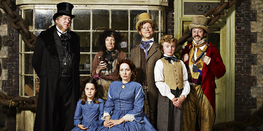 The Bleak Old Shop Of Stuff. Image shows from L to R: Malifax Skulkingworm (Stephen Fry), Victoria Secret-Past (Ambra Lily Keegan), Maggoty (Pauline McLynn), Conceptiva Secret-Past (Katherine Parkinson), Jedrington Secret-Past (Robert Webb), Victor Secret-Past (Finlay Christie), Jolliforth Jollington (David Mitchell). Copyright: BBC. The Bleak Old Shop Of Stuff. Image shows from L to R: Malifax Skulkingworm (Stephen Fry), Victoria Secret-Past (Ambra Lily Keegan), Maggoty (Pauline McLynn), Conceptiva Secret-Past (Katherine Parkinson), Jedrington Secret-Past (Robert Webb), Victor Secret-Past (Finlay Christie), Jolliforth Jollington (David Mitchell). Copyright: BBC.