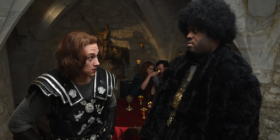 Drunk History. Image shows from L to R: Arthur (Ben Hardy), Mordred (Javone Prince). Copyright: Tiger Aspect Productions. Drunk History. Image shows from L to R: Arthur (Ben Hardy), Mordred (Javone Prince). Copyright: Tiger Aspect Productions.