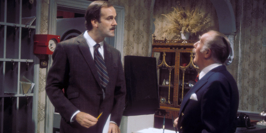 Fawlty Towers. Image shows from L to R: Basil Fawlty (John Cleese), Major Gowen (Ballard Berkeley). Copyright: BBC. Fawlty Towers. Image shows from L to R: Basil Fawlty (John Cleese), Major Gowen (Ballard Berkeley). Copyright: BBC.