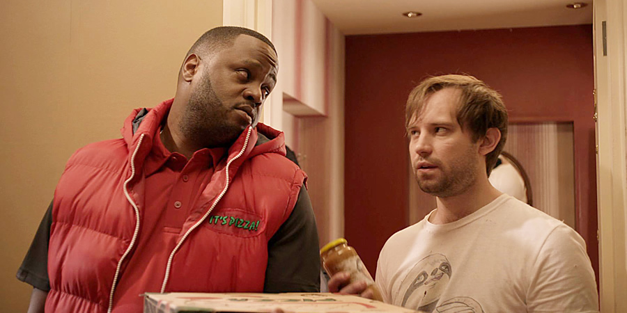 Flat TV. Image shows from L to R: Carl (Javone Prince), Naz (Naz Osmanoglu). Copyright: BBC. Flat TV. Image shows from L to R: Carl (Javone Prince), Naz (Naz Osmanoglu). Copyright: BBC.