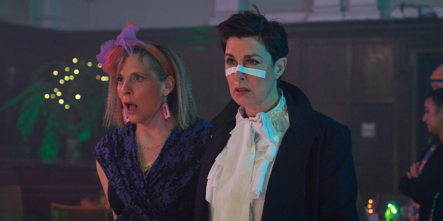 Hitmen. Image shows from L to R: Jamie (Mel Giedroyc), Fran (Sue Perkins). Copyright: Tiger Aspect Productions. Hitmen. Image shows from L to R: Jamie (Mel Giedroyc), Fran (Sue Perkins). Copyright: Tiger Aspect Productions.