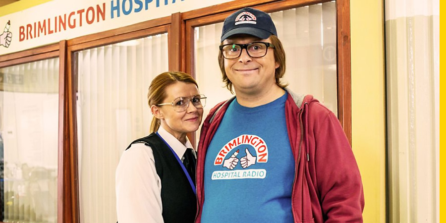 Hospital People. Image shows from L to R: Hilary (Sian Gibson), Ivan Brackenbury (Tom Binns). Copyright: Roughcut Television. Hospital People. Image shows from L to R: Hilary (Sian Gibson), Ivan Brackenbury (Tom Binns). Copyright: Roughcut Television.