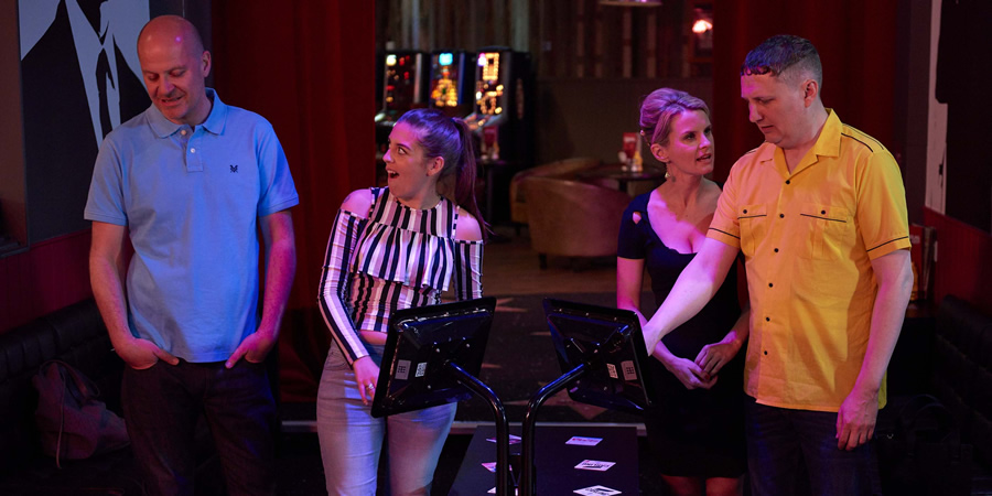 Lee And Dean. Image shows from L to R: Lee (Miles Chapman), Nikki (Camille Ucan), Mrs Bryce-D'Souza (Anna Morris), Dean (Mark O'Sullivan). Lee And Dean. Image shows from L to R: Lee (Miles Chapman), Nikki (Camille Ucan), Mrs Bryce-D'Souza (Anna Morris), Dean (Mark O'Sullivan).