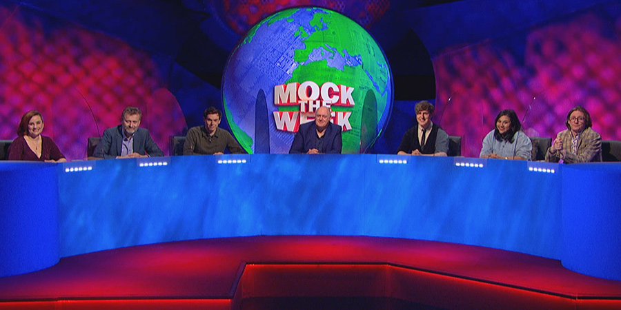 Mock The Week. Image shows from L to R: Laura Lexx, Hugh Dennis, Rhys James, Dara O Briain, Glenn Moore, Sukh Ojla, Ed Byrne. Copyright: Angst Productions. Mock The Week. Image shows from L to R: Laura Lexx, Hugh Dennis, Rhys James, Dara O Briain, Glenn Moore, Sukh Ojla, Ed Byrne. Copyright: Angst Productions.