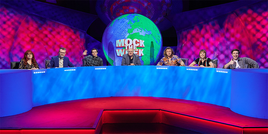 Mock The Week. Image shows from L to R: Angela Barnes, Hugh Dennis, Rhys James, Dara O Briain, Milton Jones, Maisie Adam, Ed Gamble. Copyright: Angst Productions. Mock The Week. Image shows from L to R: Angela Barnes, Hugh Dennis, Rhys James, Dara O Briain, Milton Jones, Maisie Adam, Ed Gamble. Copyright: Angst Productions.