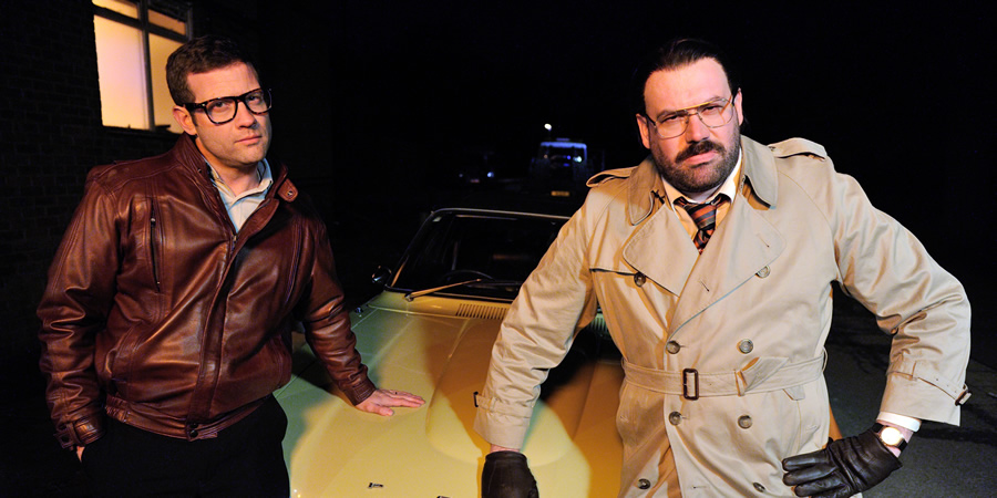 Murder In Successville. Image shows from L to R: Dermot O'Leary, DI Sleet (Tom Davis). Copyright: Tiger Aspect Productions. Murder In Successville. Image shows from L to R: Dermot O'Leary, DI Sleet (Tom Davis). Copyright: Tiger Aspect Productions.