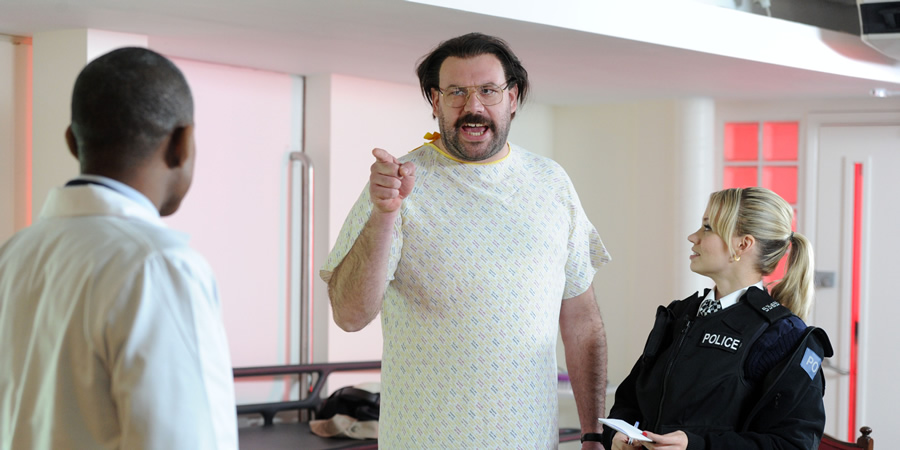 Murder In Successville. Image shows from L to R: Dr Obama (Jason Lewis), DI Sleet (Tom Davis), Kimberly Wyatt. Copyright: Tiger Aspect Productions. Murder In Successville. Image shows from L to R: Dr Obama (Jason Lewis), DI Sleet (Tom Davis), Kimberly Wyatt. Copyright: Tiger Aspect Productions.