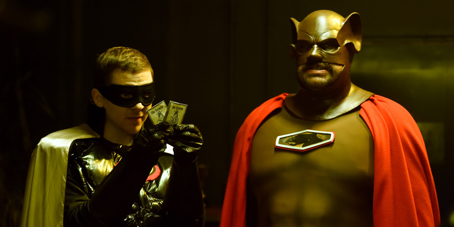 Murder In Successville. Image shows from L to R: Professor Green, DI Sleet (Tom Davis). Murder In Successville. Image shows from L to R: Professor Green, DI Sleet (Tom Davis).