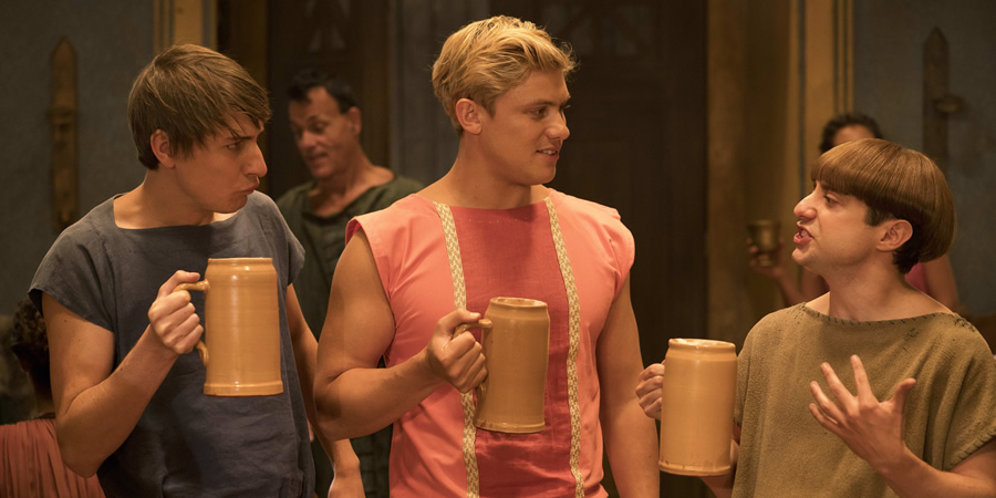 Plebs. Image shows from L to R: Marcus (Tom Rosenthal), Jason (Jon Pointing), Grumio (Ryan Sampson). Copyright: RISE Films. Plebs. Image shows from L to R: Marcus (Tom Rosenthal), Jason (Jon Pointing), Grumio (Ryan Sampson). Copyright: RISE Films.