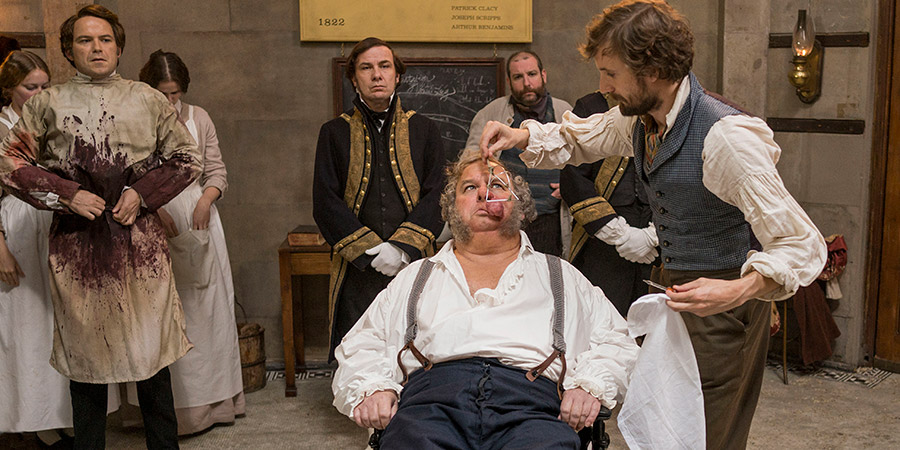Quacks. Image shows from L to R: Robert (Rory Kinnear), Unknown, Duke of Bedford (Nicholas Blane), Unknown, John (Tom Basden). Copyright: Lucky Giant. Quacks. Image shows from L to R: Robert (Rory Kinnear), Unknown, Duke of Bedford (Nicholas Blane), Unknown, John (Tom Basden). Copyright: Lucky Giant.