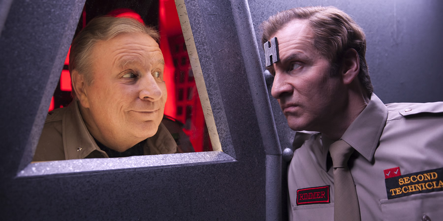 Red Dwarf. Image shows from L to R: Captain Hollister (Mac McDonald), Rimmer (Chris Barrie). Red Dwarf. Image shows from L to R: Captain Hollister (Mac McDonald), Rimmer (Chris Barrie).