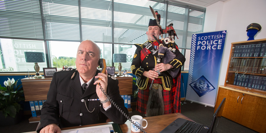 Scot Squad. Image shows from L to R: Chief Commissioner Cameron Miekelson (Jack Docherty), Unknown. Copyright: The Comedy Unit. Scot Squad. Image shows from L to R: Chief Commissioner Cameron Miekelson (Jack Docherty), Unknown. Copyright: The Comedy Unit.