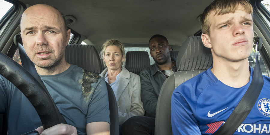 Sick Of It. Image shows from L to R: Karl (Karl Pilkington), Zoe (Kate Ashfield), Gregg (Emmanuel Ighodaro), Dylan (Finn Bennett). Sick Of It. Image shows from L to R: Karl (Karl Pilkington), Zoe (Kate Ashfield), Gregg (Emmanuel Ighodaro), Dylan (Finn Bennett).