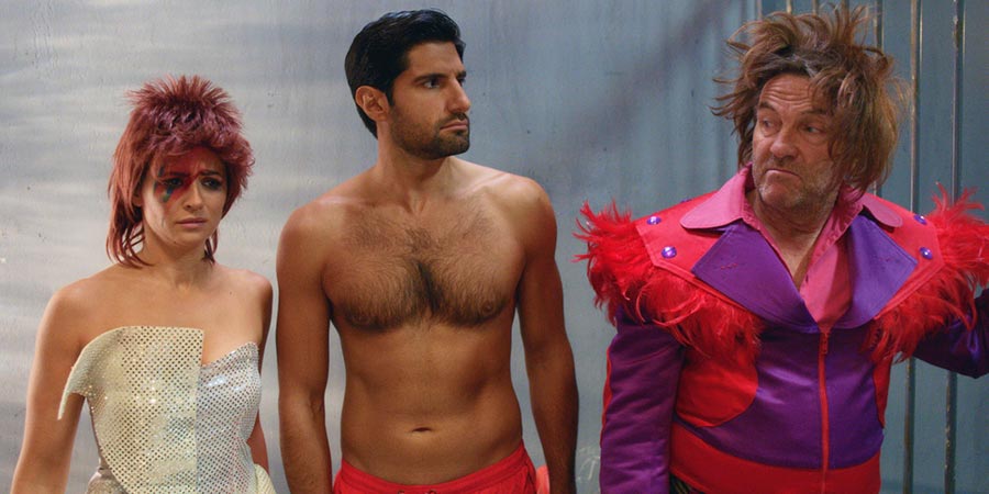 SunTrap. Image shows from L to R: Melody (Emma Pierson), Woody (Kayvan Novak), Brutus (Bradley Walsh). Copyright: Happy Tramp Productions. SunTrap. Image shows from L to R: Melody (Emma Pierson), Woody (Kayvan Novak), Brutus (Bradley Walsh). Copyright: Happy Tramp Productions.