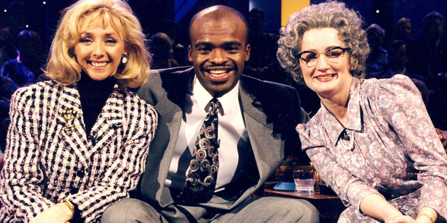 The Mrs Merton Show. Image shows from L to R: Debbie McGee, Kriss Akabusi, Mrs Merton (Caroline Aherne). Copyright: Granada Productions. The Mrs Merton Show. Image shows from L to R: Debbie McGee, Kriss Akabusi, Mrs Merton (Caroline Aherne). Copyright: Granada Productions.