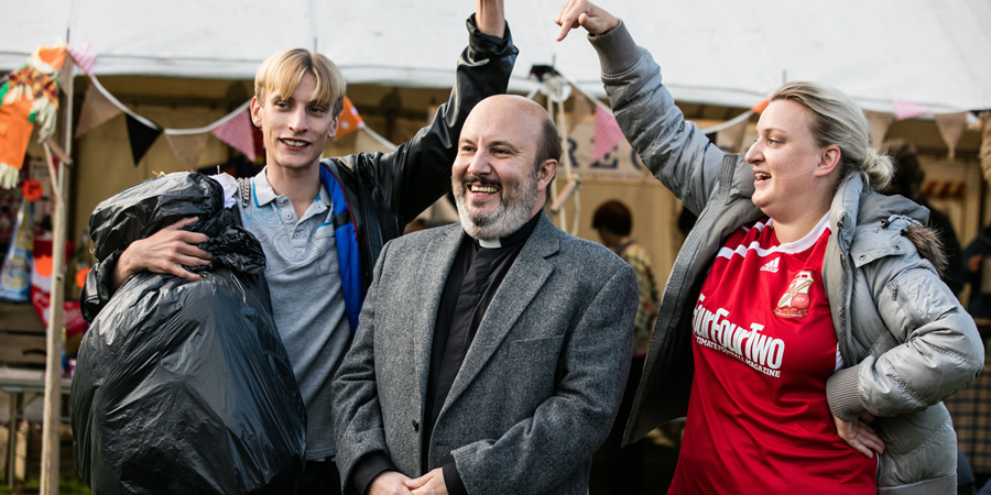 This Country. Image shows from L to R: Lee 'Kurtan' Mucklowe (Charlie Cooper), Reverend Francis Seaton (Paul Chahidi), Kerry Mucklowe (Daisy May Cooper). Copyright: BBC. This Country. Image shows from L to R: Lee 'Kurtan' Mucklowe (Charlie Cooper), Reverend Francis Seaton (Paul Chahidi), Kerry Mucklowe (Daisy May Cooper). Copyright: BBC.