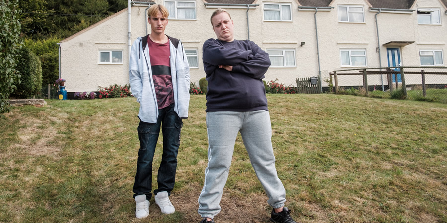 This Country. Image shows from L to R: Lee 'Kurtan' Mucklowe (Charlie Cooper), Kerry Mucklowe (Daisy May Cooper). Copyright: BBC. This Country. Image shows from L to R: Lee 'Kurtan' Mucklowe (Charlie Cooper), Kerry Mucklowe (Daisy May Cooper). Copyright: BBC.