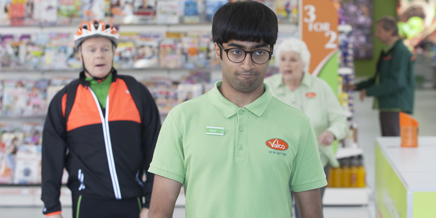 Trollied. Image shows from L to R: Gavin (Jason Watkins), Shai (Nikhil Parmar), Margaret (Rita May). Copyright: Roughcut Television. Trollied. Image shows from L to R: Gavin (Jason Watkins), Shai (Nikhil Parmar), Margaret (Rita May). Copyright: Roughcut Television.