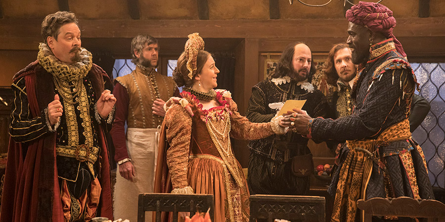 Upstart Crow. Image shows from L to R: Sir Robert Greene (Mark Heap), Bottom (Rob Rouse), Kate (Gemma Whelan), Will Shakespeare (David Mitchell), Marlowe (Tim Downie), Otello (Steve Toussaint). Copyright: BBC. Upstart Crow. Image shows from L to R: Sir Robert Greene (Mark Heap), Bottom (Rob Rouse), Kate (Gemma Whelan), Will Shakespeare (David Mitchell), Marlowe (Tim Downie), Otello (Steve Toussaint). Copyright: BBC.