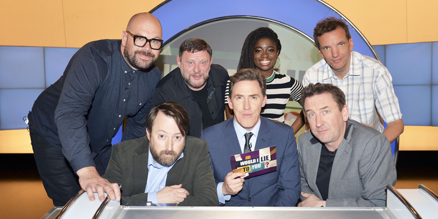 Would I Lie To You?. Image shows from L to R: Tom Davis, David Mitchell, Shaun Ryder, Rob Brydon, Clara Amfo, Lee Mack, Henning Wehn. Copyright: Zeppotron. Would I Lie To You?. Image shows from L to R: Tom Davis, David Mitchell, Shaun Ryder, Rob Brydon, Clara Amfo, Lee Mack, Henning Wehn. Copyright: Zeppotron.