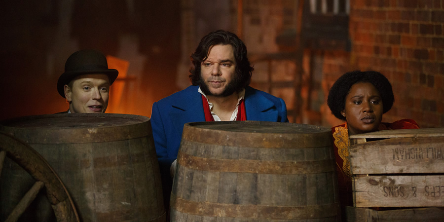 Year Of The Rabbit. Image shows from L to R: Wilbur Strauss (Freddie Fox), Detective Inspector Rabbit (Matt Berry), Mabel Wisbech (Susan Wokoma). Copyright: Objective Productions. Year Of The Rabbit. Image shows from L to R: Wilbur Strauss (Freddie Fox), Detective Inspector Rabbit (Matt Berry), Mabel Wisbech (Susan Wokoma). Copyright: Objective Productions.