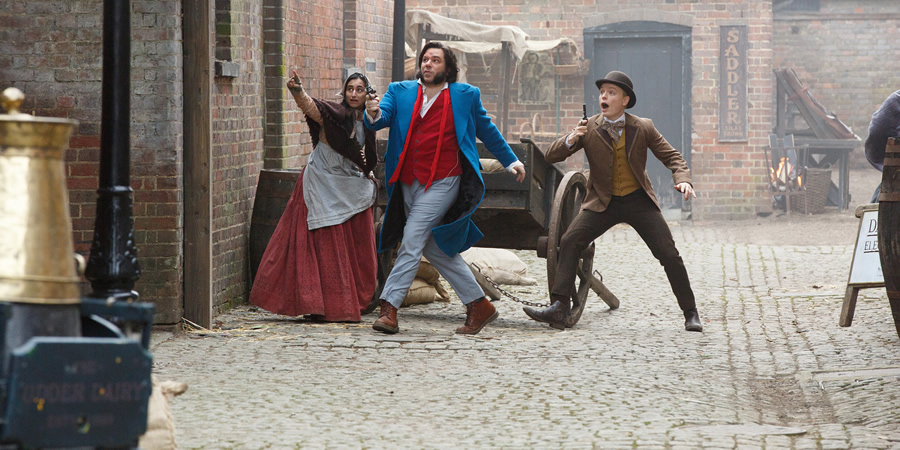 Year Of The Rabbit. Image shows from L to R: Tilly (Ashna Rabheru), Detective Inspector Rabbit (Matt Berry), Wilbur Strauss (Freddie Fox). Copyright: Objective Productions. Year Of The Rabbit. Image shows from L to R: Tilly (Ashna Rabheru), Detective Inspector Rabbit (Matt Berry), Wilbur Strauss (Freddie Fox). Copyright: Objective Productions.