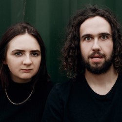 Miller and Salmon: Genesis. Image shows from L to R: Lucy Miller, Benjamin Salmon. Miller and Salmon: Genesis. Image shows from L to R: Lucy Miller, Benjamin Salmon.