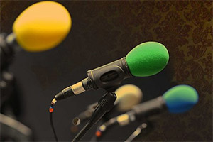 A number of microphones in stands. A number of microphones in stands.