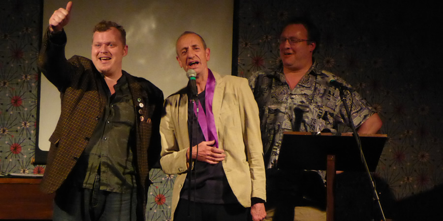 Arthur Smith picking up the Bath Plug Award 2019. Image shows from L to R: Jem Roberts, Arthur Smith, Nick Steel. Copyright: Alan Cassé. Arthur Smith picking up the Bath Plug Award 2019. Image shows from L to R: Jem Roberts, Arthur Smith, Nick Steel. Copyright: Alan Cassé.