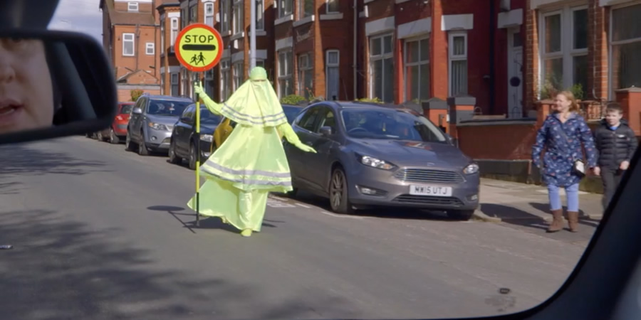 Lollypop lady wearing a florescent Burqa. Lollypop lady wearing a florescent Burqa.