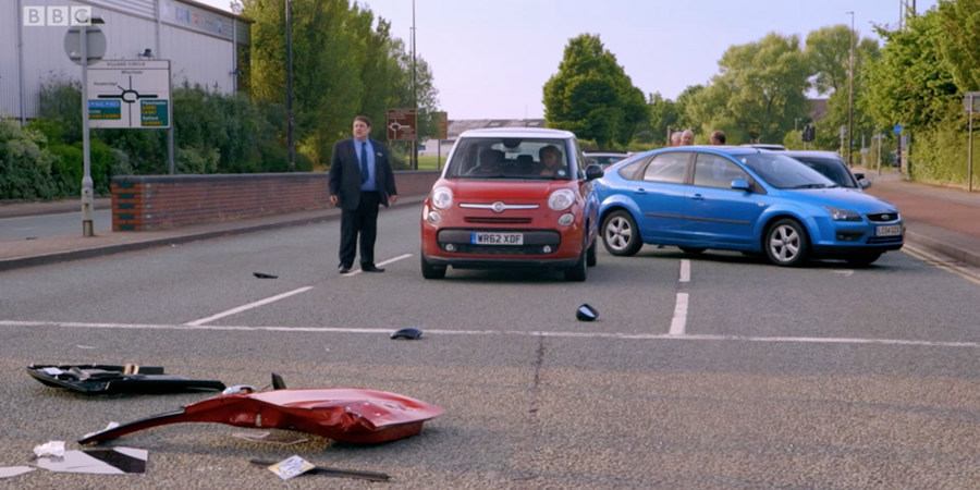 Car crash scene - with NOW CD. Copyright: Goodnight Vienna Productions. Car crash scene - with NOW CD. Copyright: Goodnight Vienna Productions.