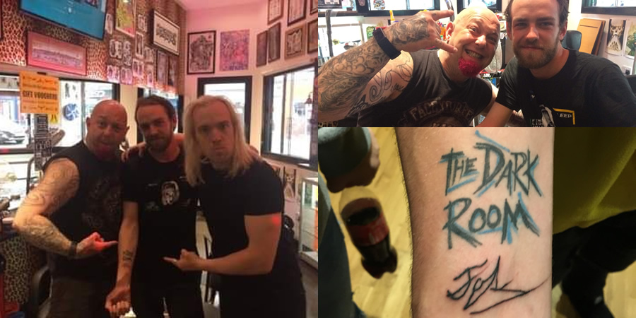 Man getting The Dark Room tattoo. Man getting The Dark Room tattoo.